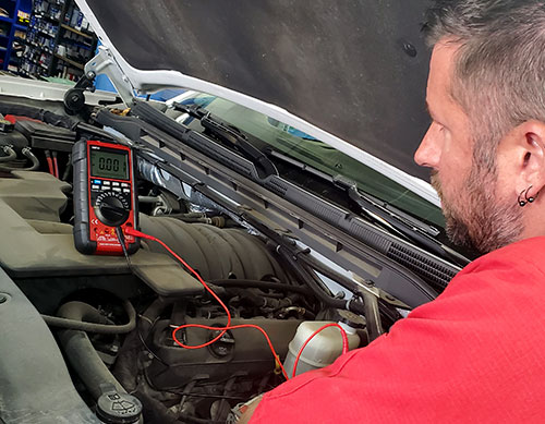 mechanic checking automobile electrical system photo